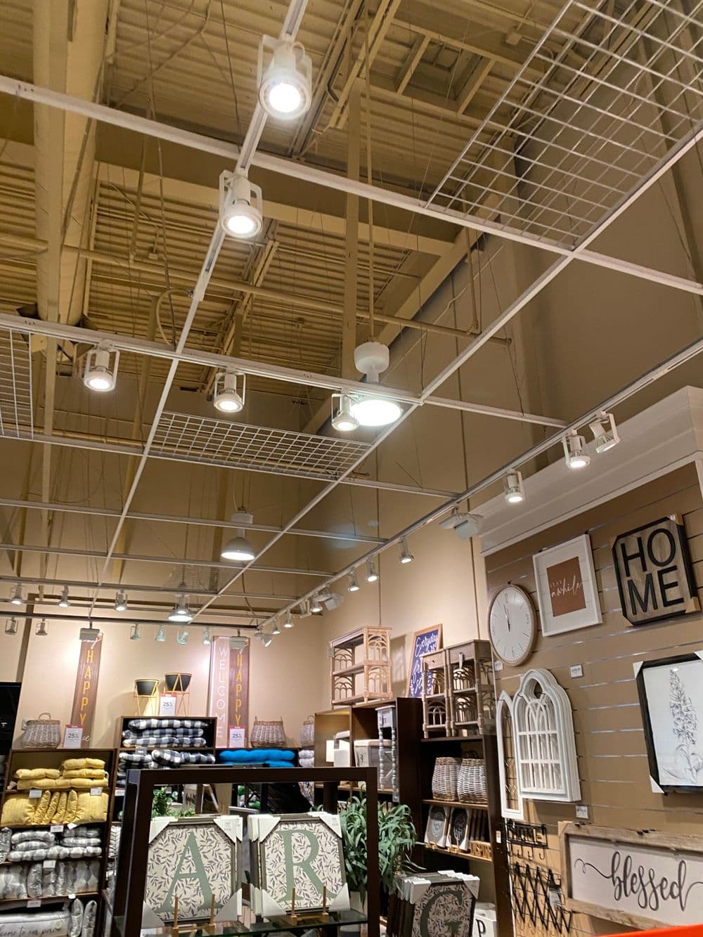 Ceiling view of a retail space showcasing decorative lighting and home decor items.