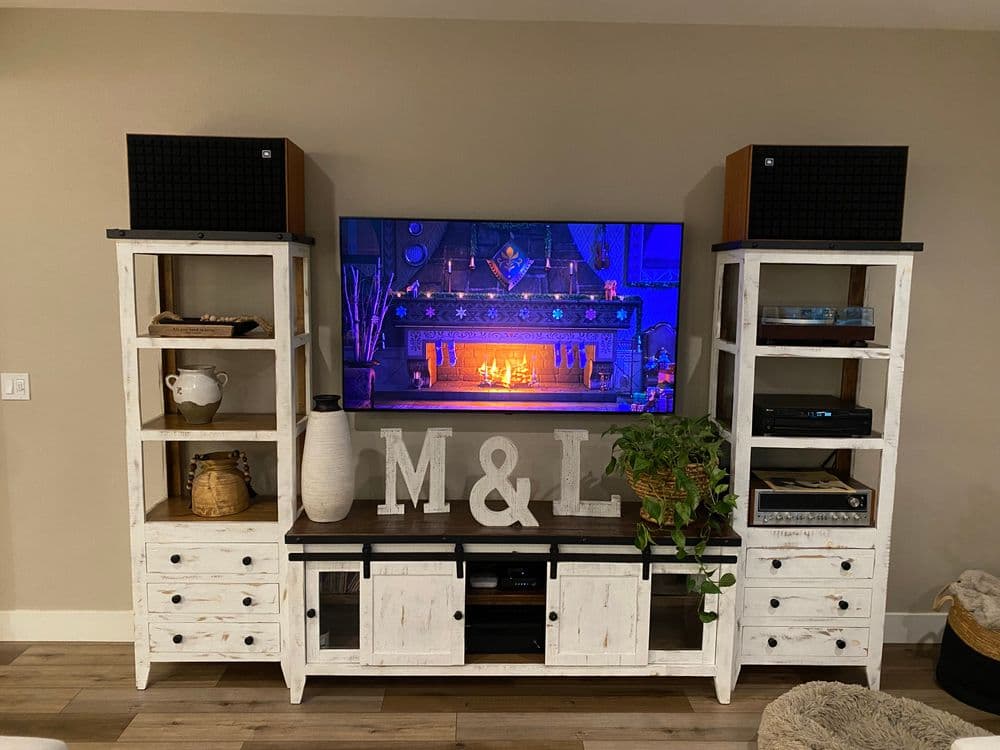 Modern living room entertainment center with shelves, TV, and decorative initials M&L.